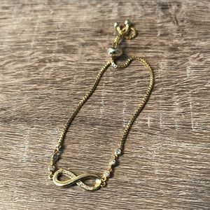Gold Infinity bracelet with CZ sparkly stones NWOT Toggle adjustable